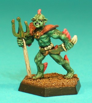 Pose 3, variant A. This Sahuagin is armed with a trident and a curved dagger. He wears a decorated belt and loancloth and a set of shoulder armour. This particular variant has a narrow, pointed face, with angular ears and a 4-spined fin on the back of his head. He has small, oval eyes, his mouth is partly open in a snarl, and his head is turned to his left.